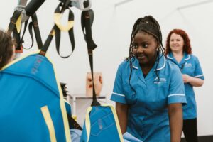 Nursing student using a hoist