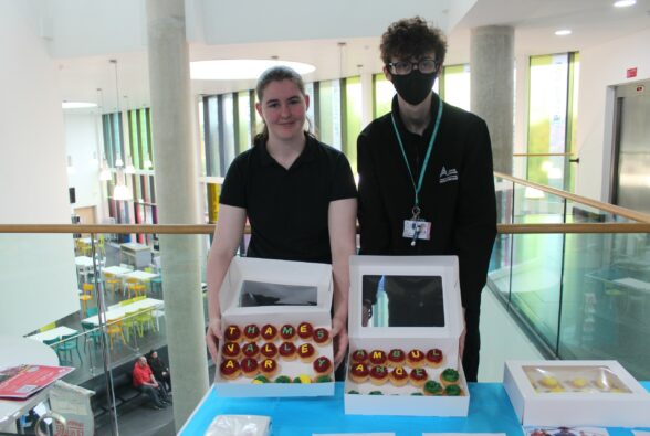 Lily Warner and Shay Tattersall selling some cakes and biscuits