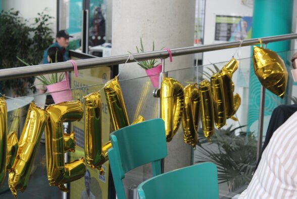 Balloons saying well done.