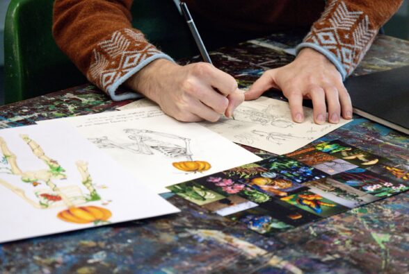 Art and Design student Oliver Bolter sketching his Skeleton design Skeletons-7 credit Chloe Diana Studios