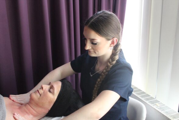 Lilli Heron-Jason gives a shoulder massage to a client as part of a facial treatment. 