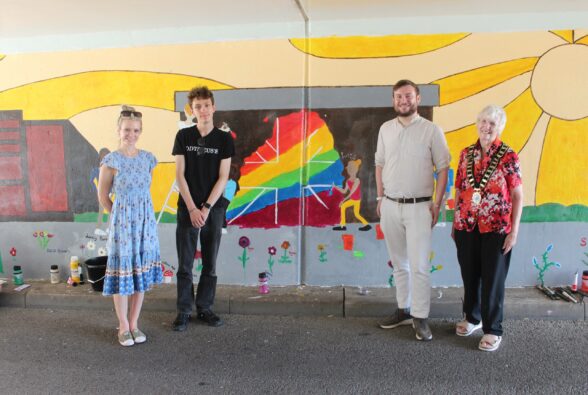 Group photo: Left to right: Cllr Helen Purnell, Leader of Bracknell Forest Council, Art student, Presley Shearer, from Bracknell and Wokingham College, Peter Swallow MP, Member of Parliament for Bracknell, Crowthorne, Sandhurst and Whitegrove and Councillor Kathleen Nugent, Bracknell Town Mayor standing in front of the mural.